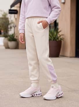 A matching soft lilac or cream-colored fleece tracksuit consisting of oversized joggers and a cropped sweatshirt for a coordinated athleisure look.