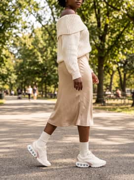 Air Max Dn Se – Casual Feminine: Style with a satin midi skirt in a champagne hue and a chunky knit off-the-shoulder sweater for a balanced blend of textures and styles.