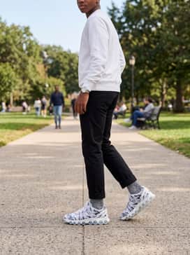 Air Max Dn8 Premium – Slim-fit black chinos paired with a crisp white crewneck sweatshirt for a clean, elevated casual aesthetic.