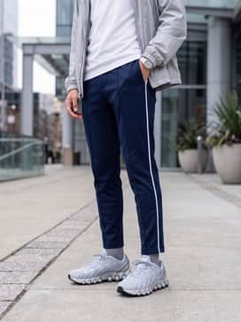 Elevated athletic-casual: Combine with slim-fit navy track pants featuring a white side stripe, a crisp white performance t-shirt, and a lightweight silver windbreaker for a sleek, sporty vibe.