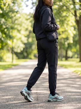 Black nylon utility joggers paired with a technical windbreaker and a sleek crossbody bag for a modern, functional urban outfit.