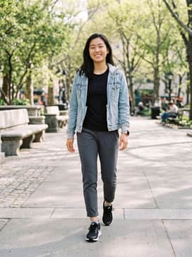 High-waisted black leggings paired with a crisp white oversized graphic tee and a light-wash denim jacket for a versatile weekend look.