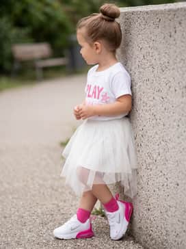 Air Max Phoenix – A white tutu skirt and a graphic tee with pink lettering to balance sporty functionality with a whimsical, feminine touch.