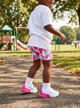 Brightly patterned cycling shorts and an oversized white T-shirt for a modern, comfortable summer outfit that allows for maximum movement.