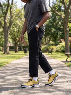 Relaxed-fit black chinos paired with an oversized vintage-wash band tee and a silver chain necklace to lean into a modern streetwear vibe.