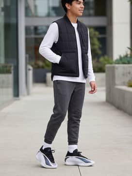For a sharp classroom look, wear these with charcoal grey tapered joggers and a layered long-sleeve white t-shirt under a black quilted vest for a modern, functional aesthetic.