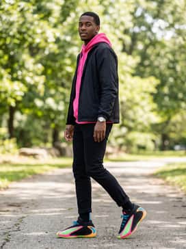 Anthony Edwards 2 Shoes – A high-energy urban outfit pairing slim-fit black denim with a hot pink hoodie under a black windbreaker to make the neon accents pop.