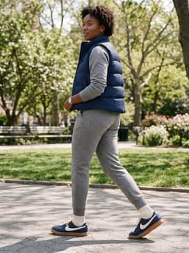 Heather grey tapered joggers with a matching cropped hoodie and a sleek navy puffer vest for a high-end athleisure vibe that highlights the shoe's silhouette.