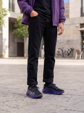 Ava Rover – Straight-leg medium wash denim jeans with cuffed hems, a white graphic t-shirt, and a matching purple windbreaker.