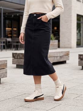 A black midi slip dress layered with a cropped cream knit sweater to echo the shoe's color palette while remaining feminine.