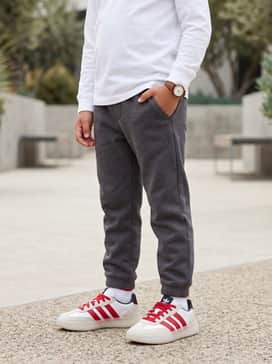 Style with charcoal grey joggers and a crisp white long-sleeve tee for a clean, athletic-inspired outfit perfect for the playground.