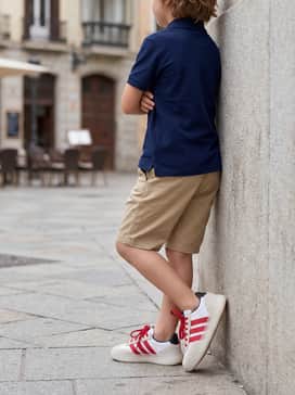 Combine with khaki chino shorts and a navy blue polo shirt for a smart-casual ensemble suitable for school or family outings.