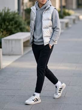 Black tapered joggers paired with a heather grey hoodie and a metallic silver puffer vest for a coordinated, futuristic look.