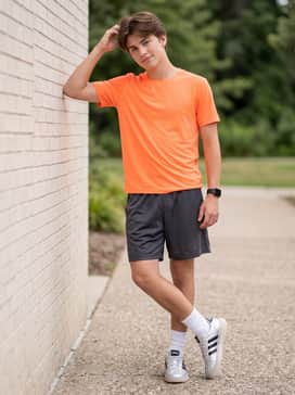 Athletic charcoal mesh shorts and a neon-colored moisture-wicking tee for high-energy sports and outdoor fun.