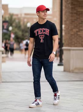 A black Texas Tech graphic t-shirt paired with slim-fit dark wash jeans and a red baseball cap for the ultimate game-day fan look.