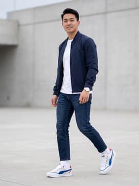 Bmw M Motorsport Park Sk8 Mens Sneakers – Dark wash slim-fit denim jeans paired with a crisp white crew-neck t-shirt and a navy blue bomber jacket.