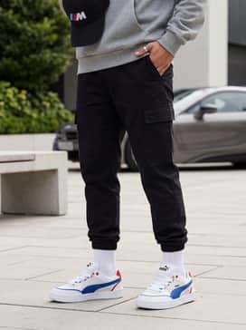 Tapered black cargo joggers combined with an oversized grey hoodie and a matching BMW M branded baseball cap.