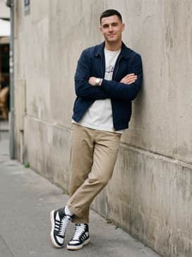 Break Start Mid Shoes – Khaki chino trousers with a slight crop, worn with a tucked-in graphic tee and a lightweight navy Harrington jacket for a smart-casual weekend vibe.