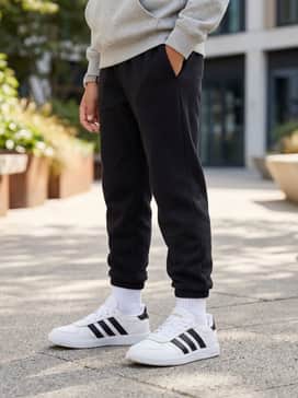 Black athletic joggers worn with a heather grey hoodie and a matching baseball cap for a sporty, streetwear-inspired ensemble.