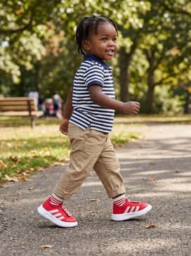 Bubblecomfy Shoes – Khaki chinos and a striped polo shirt in navy and white to balance the vibrant red shoes with a touch of smart-casual flair.