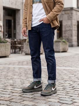 Combine with slim-fit dark indigo jeans, a crisp white graphic t-shirt, and an unbuttoned tan corduroy overshirt for a textured casual vibe.