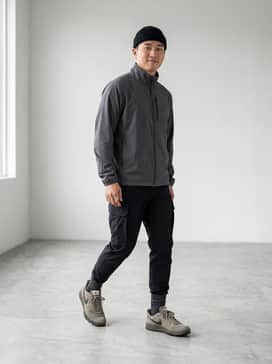 C1ty Surplus – Tapered black cargo pants paired with a charcoal grey technical windbreaker and a black rib-knit beanie for a sleek urban ninja aesthetic.