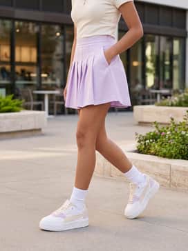 A light lilac tennis skirt matched with a fitted cream polo shirt and white crew socks to highlight the sneaker's platform sole.