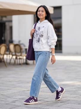 Baggy light-wash denim jeans paired with an oversized white graphic hoodie to lean into the chunky 00s aesthetic.