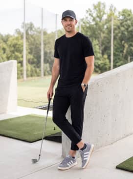 Black slim-fit joggers, a moisture-wicking black athletic tee, and a technical baseball cap for a focused and comfortable session at the driving range.