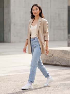 Polished Streetwear: High-waisted light-wash straight-leg jeans, a tucked-in cream-colored silk camisole, and an oversized beige blazer for a chic, balanced look.