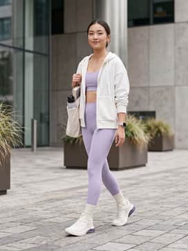 Cell Thrill Womens Running Shoes – High-waisted lavender compression leggings paired with a matching sports bra and a white oversized zip-up hoodie for a cohesive gym-ready look.