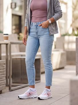 Cloud 6 Push – Light-wash slim-fit denim jeans with a slight cuff, styled with a tucked-in mauve rib-knit tank top and a grey zip-up hoodie for a coordinated weekend outfit.