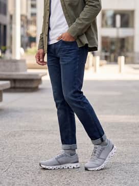 Cloud X 4 – Dark wash athletic-fit jeans paired with a crisp white heavyweight t-shirt and an unbuttoned olive green overshirt for a layered, versatile urban aesthetic.