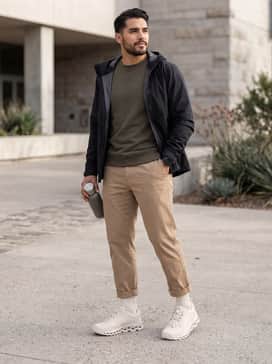 Slim-fit navy joggers combined with a heather grey oversized hoodie and a black water-resistant windbreaker for a sporty city look.