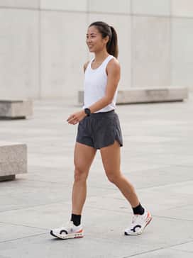 Cloudboom Echo 3 – Professional race-day kit featuring ultra-lightweight charcoal split shorts, a moisture-wicking white technical singlet, and low-profile compression socks.