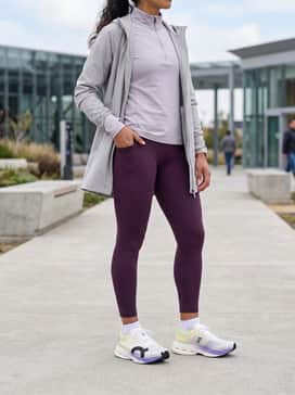 A high-performance training ensemble with deep plum compression leggings to match the midsole accent, paired with a lilac breathable long-sleeve quarter-zip.