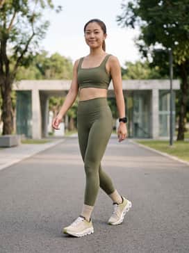 A high-performance olive green compression set consisting of 7/8 leggings and a matching square-neck sports bra for a cohesive, monochromatic athletic look.