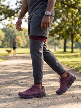 A relaxed weekend fit pairing slim-fit dark indigo denim, a simple heather grey crewneck sweatshirt, and a quilted navy vest for a polished yet functional appearance.