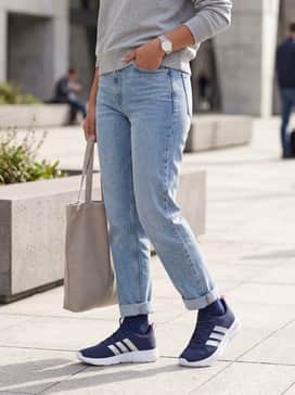 Cloudfoam Flex Slounge Shoes – Cropped light-wash straight-leg jeans with a tucked-in grey marl crewneck sweatshirt and silver-toned jewelry to complement the metallic stripes.