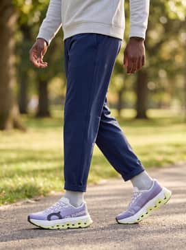 Cloudmonster 3 Hyper – A post-workout recovery ensemble featuring navy blue track pants, a light grey quarter-zip pullover, and a matching lavender headband.