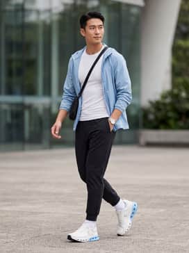 Cloudnova X – A performance-focused look featuring black tapered tech joggers, a fitted white moisture-wicking compression shirt, and a light blue windbreaker to echo the shoe's midsole.