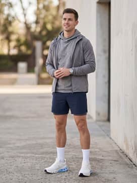 Cloudnova X – A workout-ready outfit with navy blue 7-inch performance shorts, a heather grey sleeveless training hoody, and white crew-length athletic socks for a classic gym silhouette.