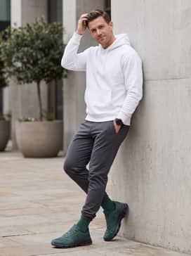 Casual off-duty style with heather grey tapered sweatpants and a crisp white oversized hoodie for high contrast.
