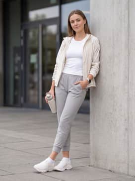Cloudpulse 2 – Tapered light grey joggers with a fitted ribbed tank top and a lightweight technical windbreaker for a functional outdoor workout layer.