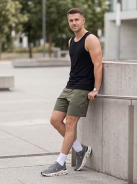 Combine the shoes with olive green tech-fabric shorts and a black breathable tank top for a rugged, outdoor-inspired training outfit.