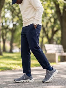 Create a sleek streetwear ensemble by wearing them with dark navy chinos, a cream-colored crewneck sweatshirt, and a matching baseball cap.
