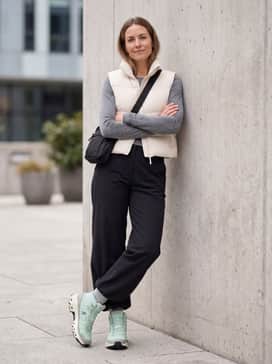 Embrace the urban Gorpcore aesthetic by pairing the boots with wide-leg black technical trousers, a cropped cream-colored puffer vest over a long-sleeve grey athletic tee, and a crossbody utility bag.