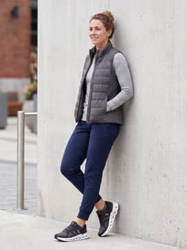 Combine with tapered navy joggers, a fitted long-sleeve moisture-wicking top in a light grey, and a technical quilted vest for a comfortable transition from the gym to a coffee date.