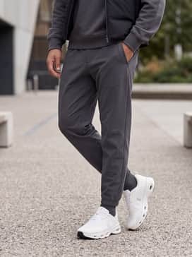Cloudsolo Loewe – Tapered black technical joggers, a charcoal grey oversized hoodie, and a matte black gilet to lean into the tech-focused aesthetic.