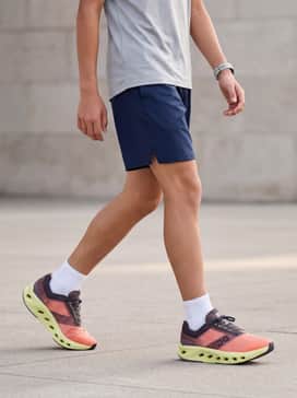 Navy blue moisture-wicking athletic shorts and a light grey performance t-shirt for a sleek, focused gym class look.